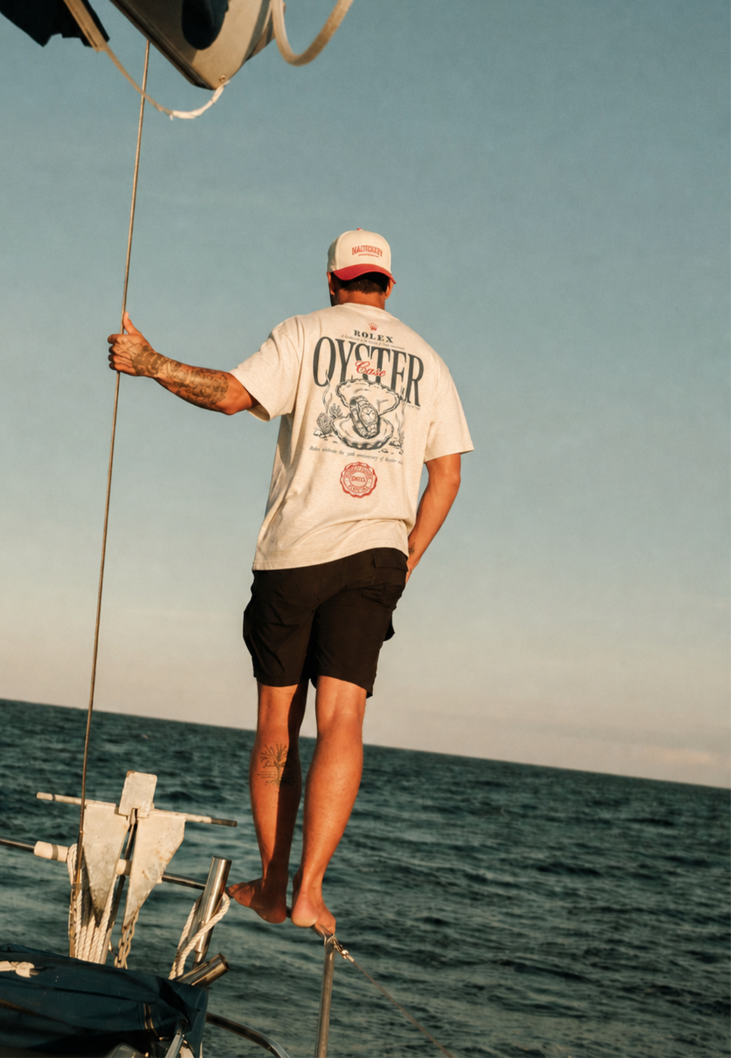 Sailor balancing on a yacht in a Horsemen Ranch Oyster shirt